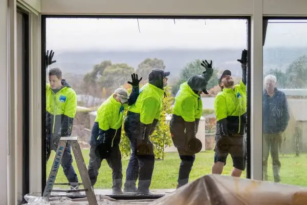 Macedon Ranges glaziers team installing large picture window in a house in Kyneton
